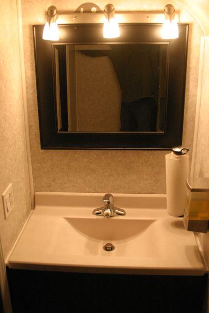 Restroom vanity with mirror and sink